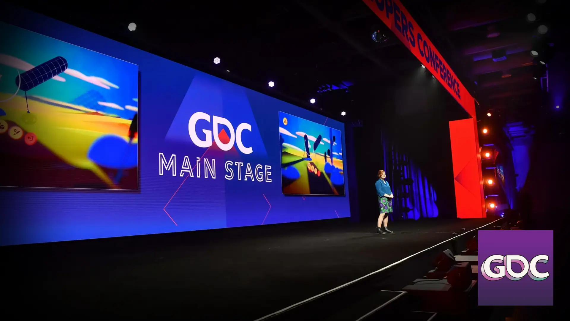 GDC conference stage with speaker and presentation screen.