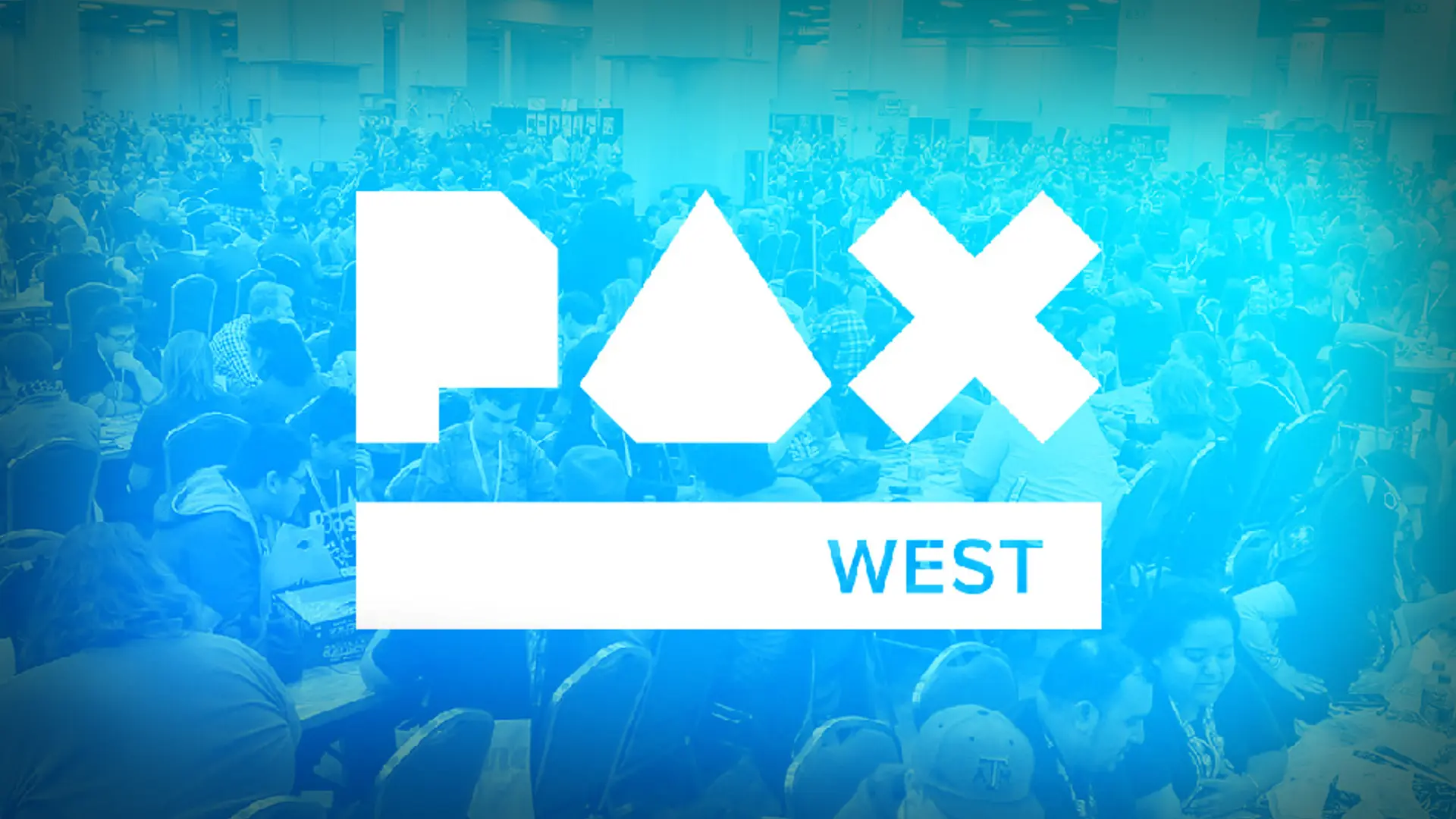 The white PAX West logo, featuring geometric shapes and the word "WEST," is overlaid on a blue-tinted photograph of a large, crowded convention hall filled with attendees.