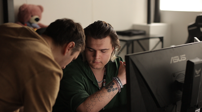 VSQUAD team reviewing game production work at the studio