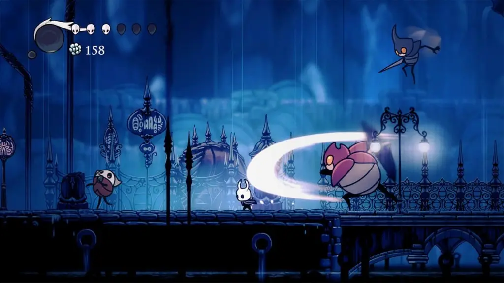 The Knight battles enemies in Hollow Knight, showcasing the game's iconic hand-drawn 2D animation and art style.