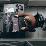 2D artist working at a professional digital workstation with a pen display and dual monitors.